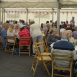 elderly people sitting in marquee at Jubilee picnic