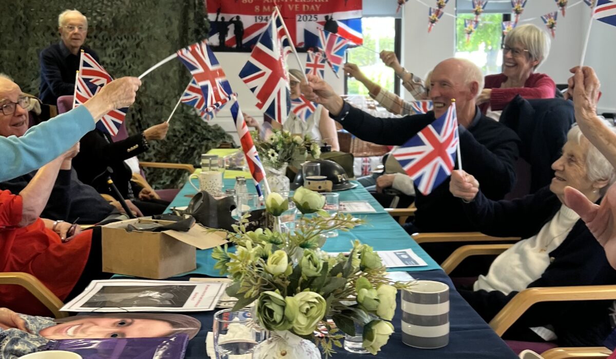 VE Day round the table waving union jacks