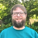 A photo of Jeremy wearing the HI Friends sweatshirt.