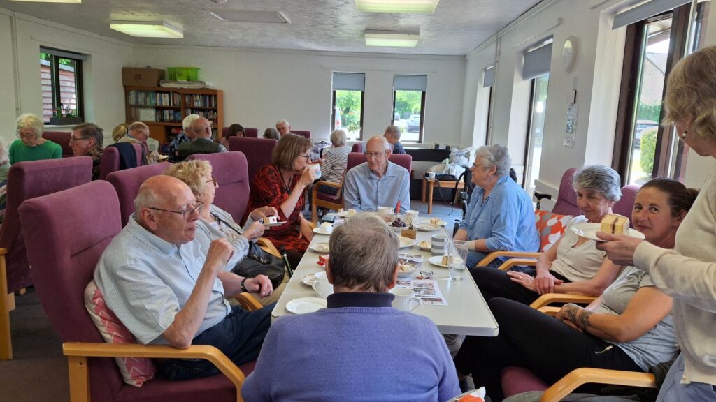 Elderly people eating round a table at Kay Hitch Way Community Centre.