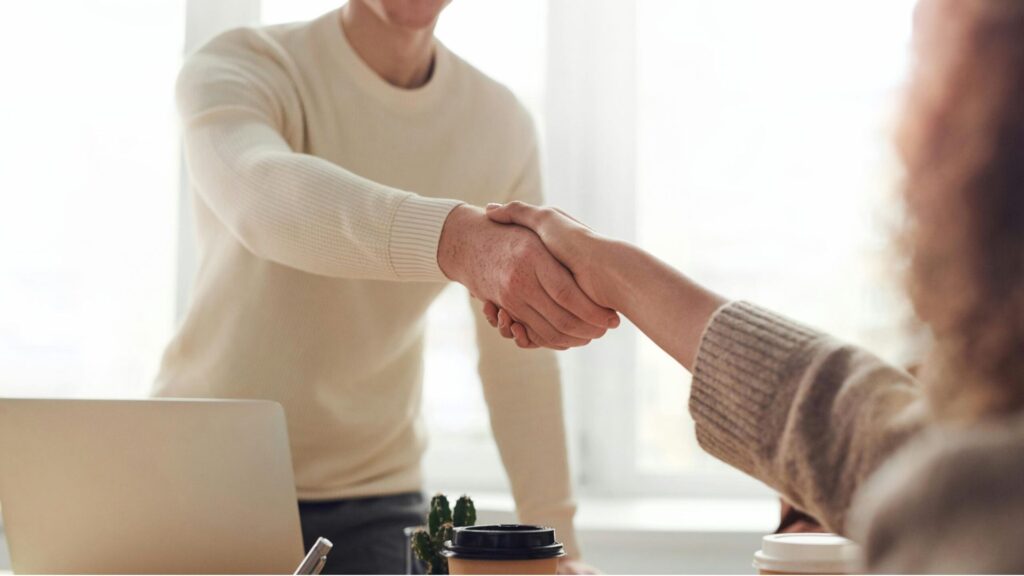 Two people shaking hands 16 x 9.
